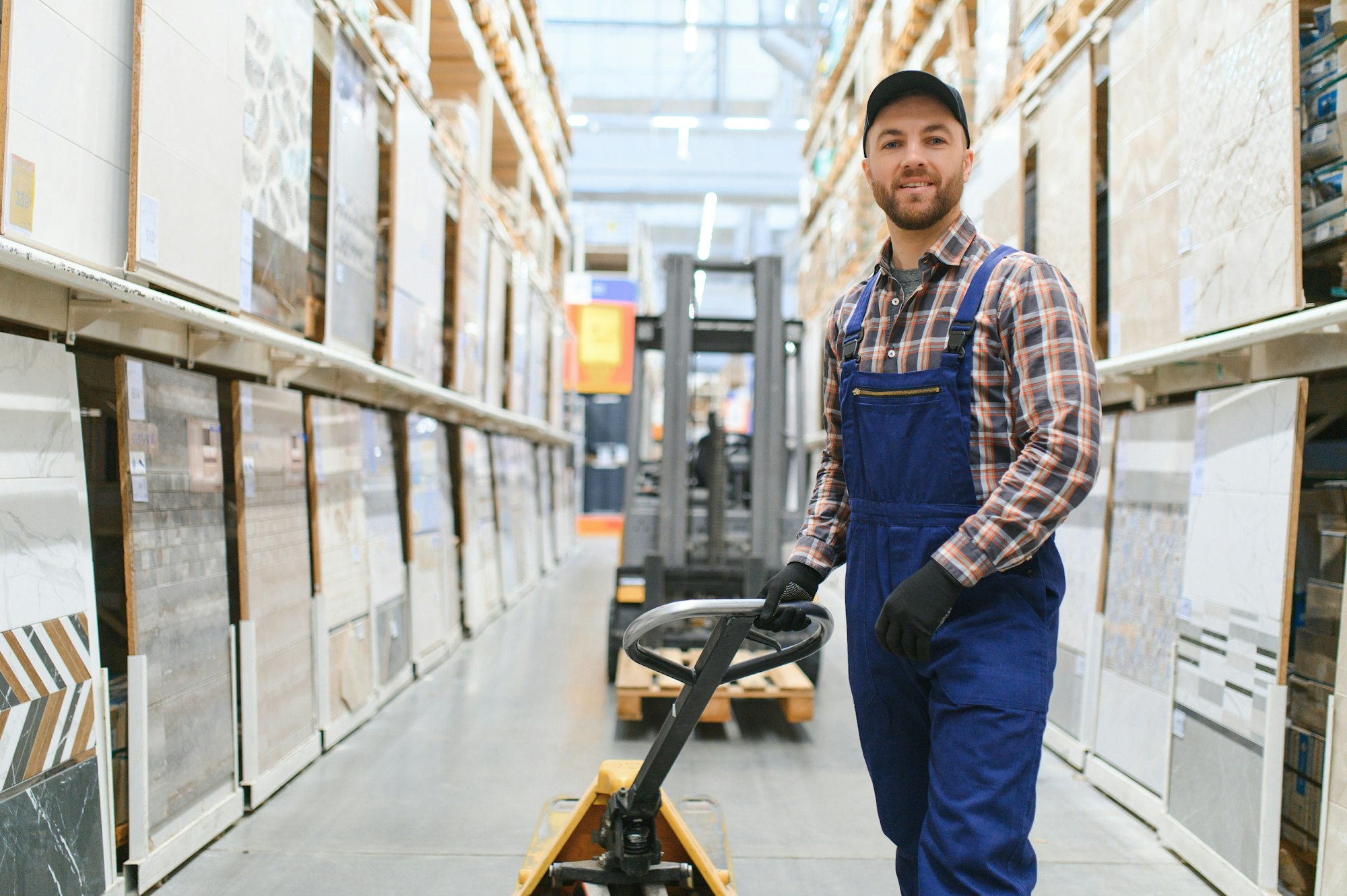 a worker in a hardware store stands in a warehouse