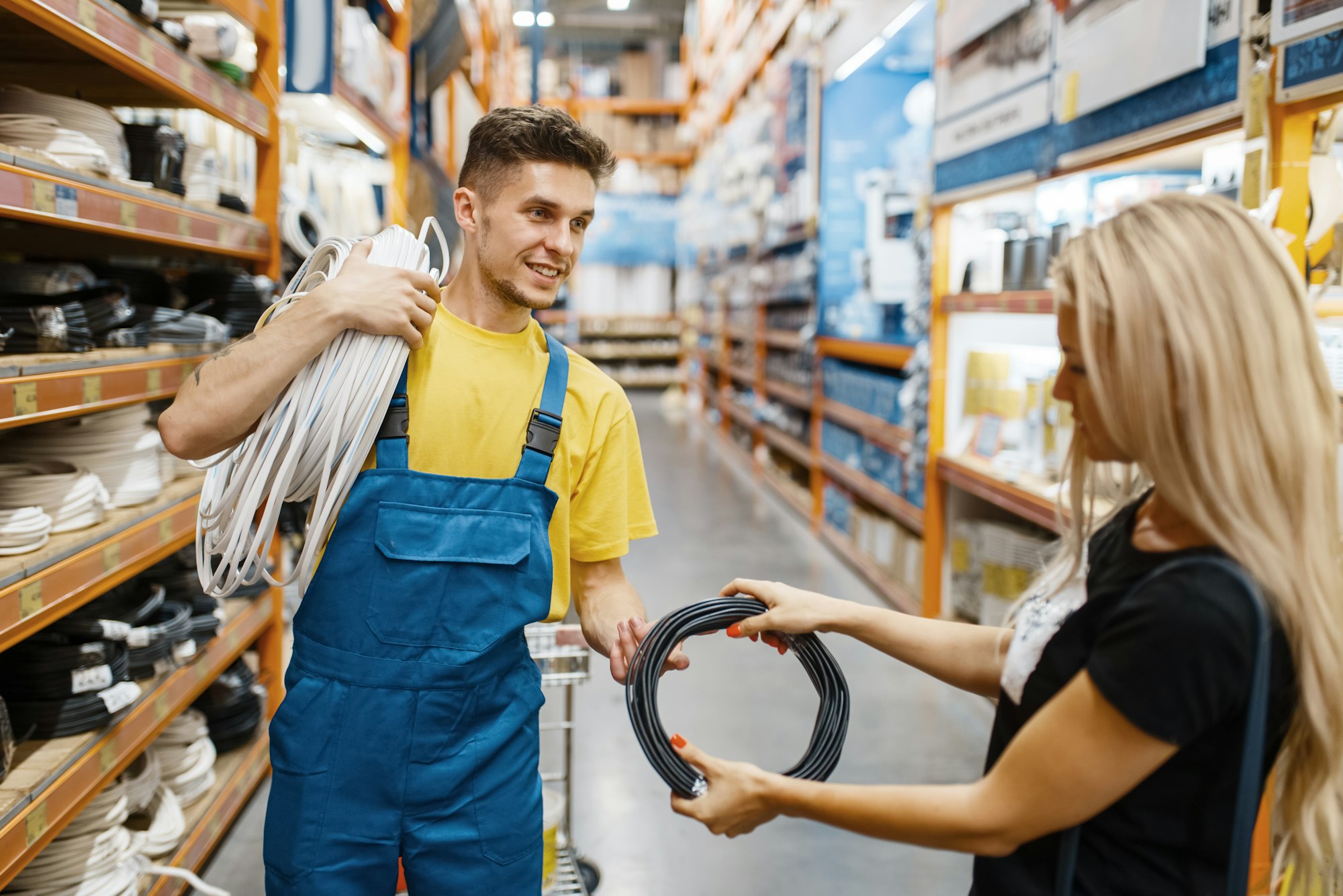Assistant and female customer with wires, diy