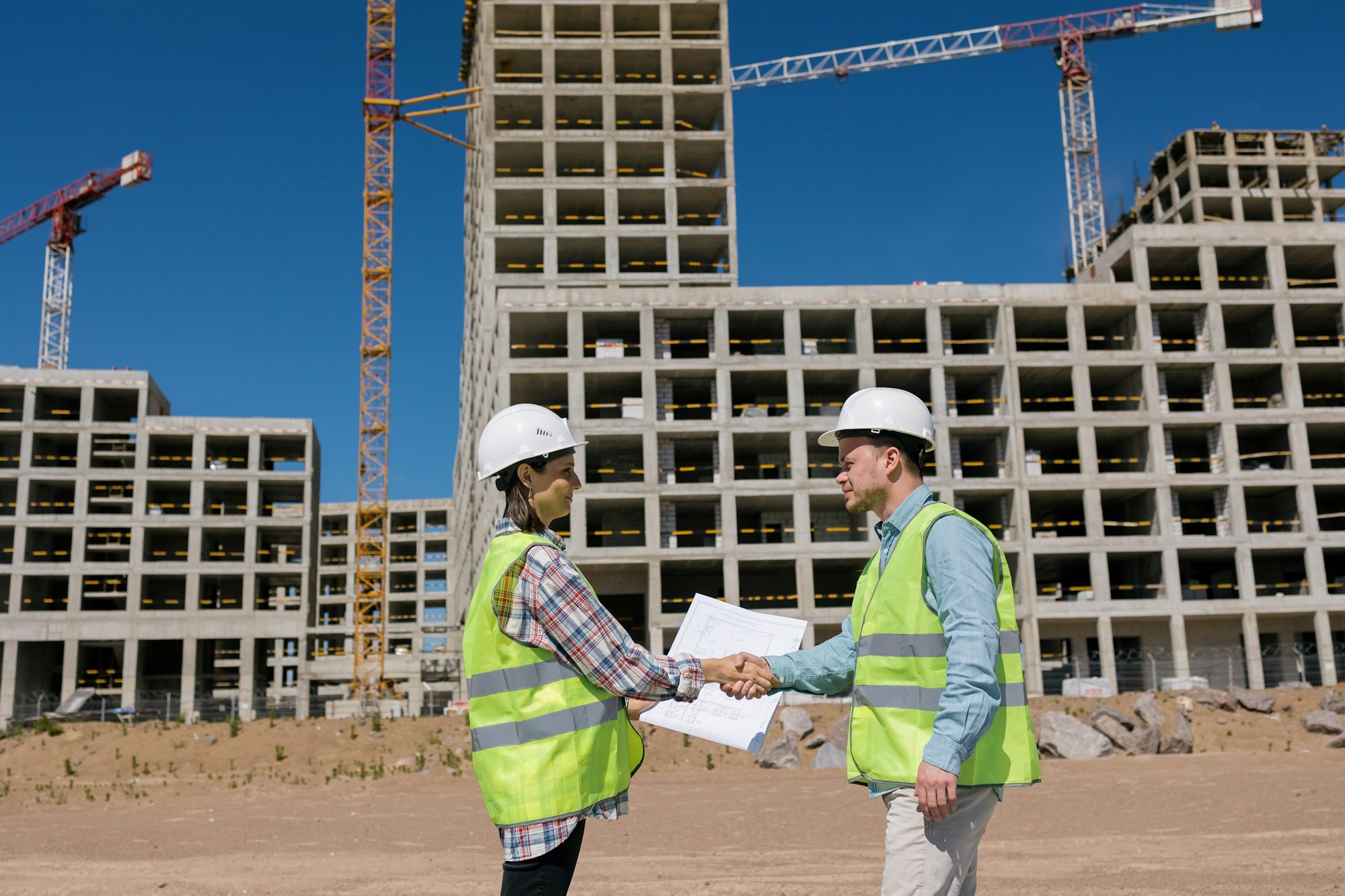 looking at the construction plan at the construction site of a residential building